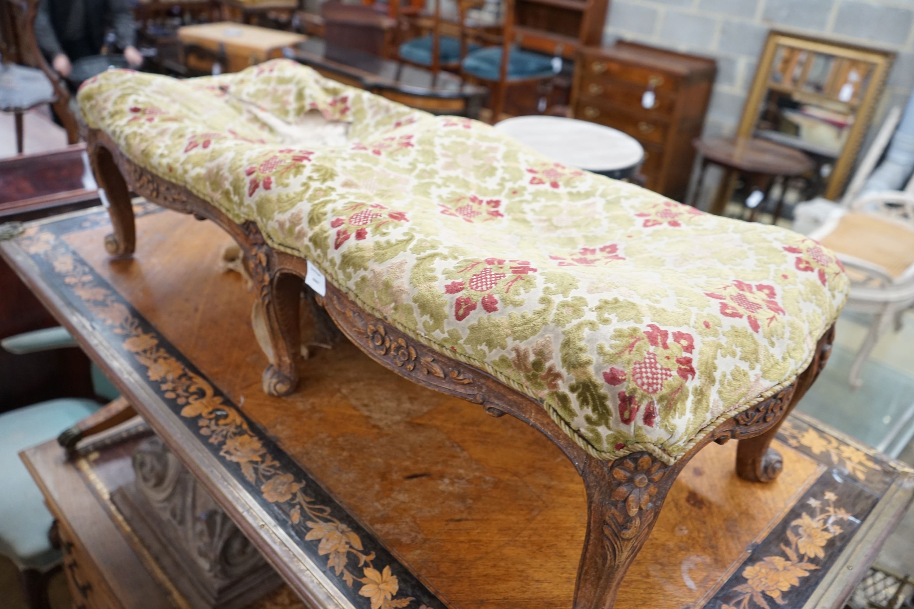 A Victorian walnut fender stool requiring re-upholstery, length 108cm, depth 40cm, height 33cm